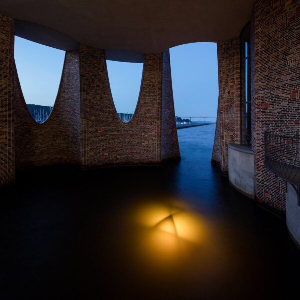 A glowing steel sphere lies submerged beneath Fjordenhus