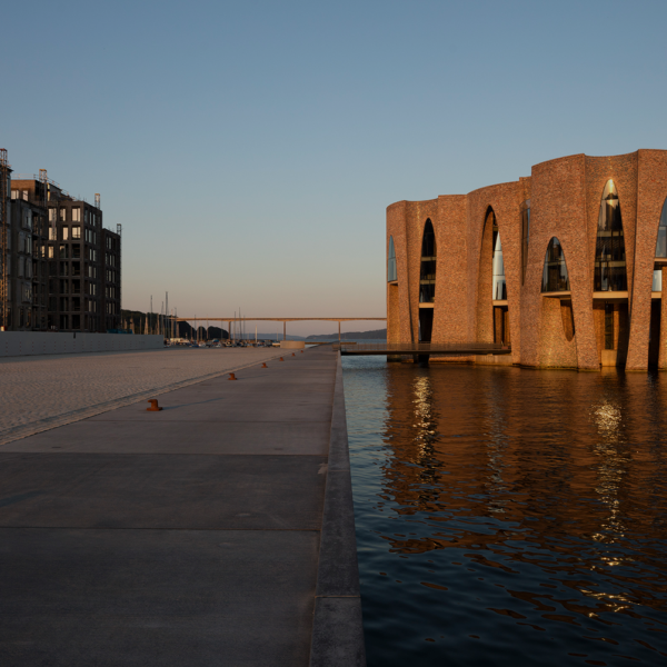 Fjordenhus rises from the waters of Vejle’s harbor