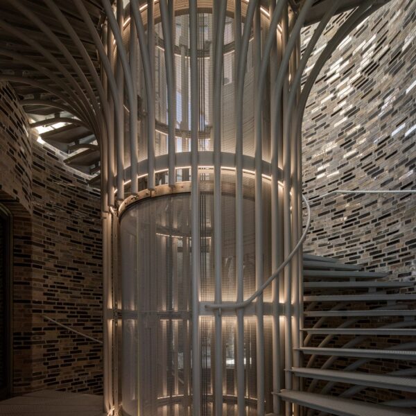 Silver-stained stairs spiral upwards towards the light